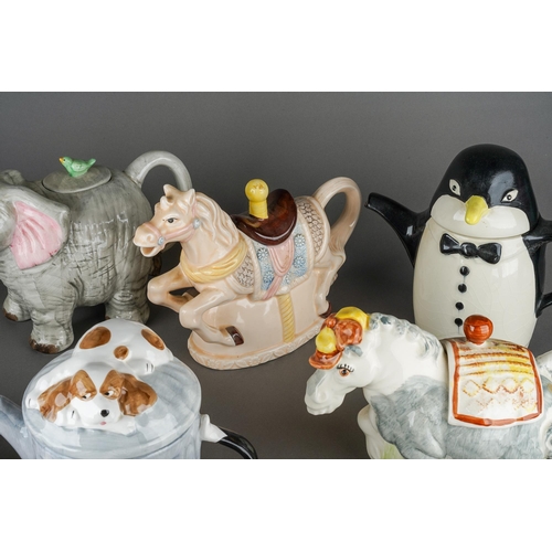 66 - A collection of assorted novelty teapots including Penguin, Carousel Horse, Elephant, Pigs etc [1 bo... 