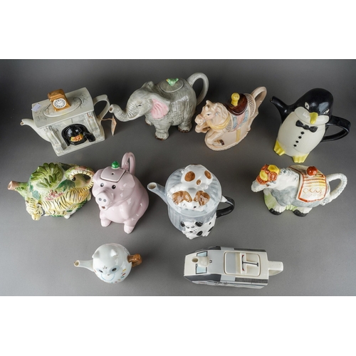 66 - A collection of assorted novelty teapots including Penguin, Carousel Horse, Elephant, Pigs etc [1 bo... 