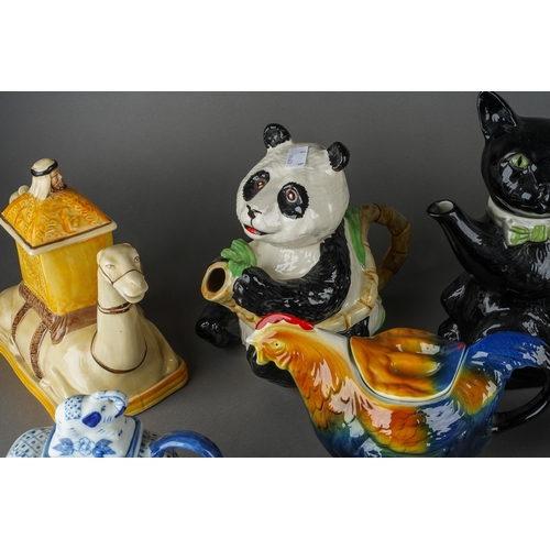 67 - A collection of novelty teapots including Black Cat, Camel, Panda, Dog, Owl, Cats, various factories... 