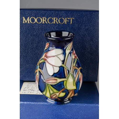73 - Four Moorcroft small vases to include: 
1. Violet, 46/4, printed and painted marks, approx 10cm, box... 