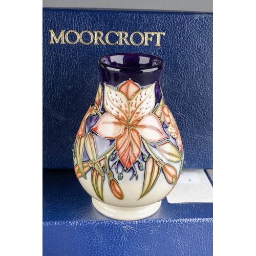 73 - Four Moorcroft small vases to include: 
1. Violet, 46/4, printed and painted marks, approx 10cm, box... 