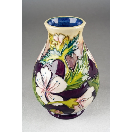 77 - A Moorcroft Mallow [Herb Collection] vase, designed by Philip Gibson, released 1999, printed and pai... 