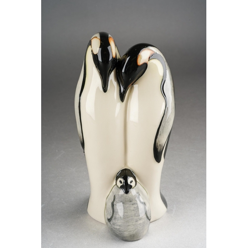 98 - A Moorcroft model of a Penguin family [two adults and chick], 2009 date cypher, printed and painted ... 