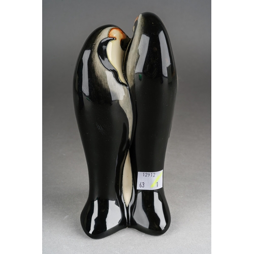 98 - A Moorcroft model of a Penguin family [two adults and chick], 2009 date cypher, printed and painted ... 