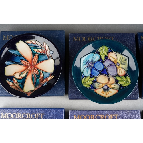 103 - Six boxed Moorcroft coasters or pin dishes, all with printed and painted marks, approx 12cm diam, to... 