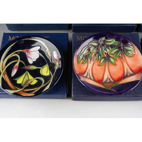 103 - Six boxed Moorcroft coasters or pin dishes, all with printed and painted marks, approx 12cm diam, to... 