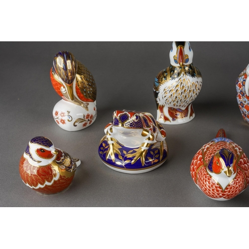 134 - A collection of ten Royal Crown Derby paperweights, three with gold stoppers and first quality, comp... 