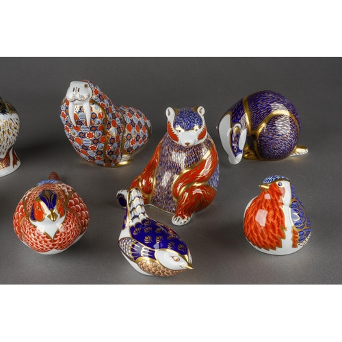 134 - A collection of ten Royal Crown Derby paperweights, three with gold stoppers and first quality, comp... 