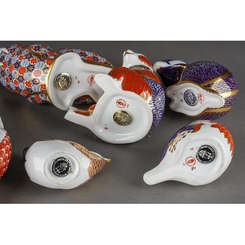 134 - A collection of ten Royal Crown Derby paperweights, three with gold stoppers and first quality, comp... 