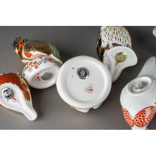 134 - A collection of ten Royal Crown Derby paperweights, three with gold stoppers and first quality, comp... 