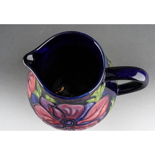 154 - A Moorcroft Anemone jug on cobalt blue ground, impressed mark, WM initials, 34/94, approx 14.5cm tal... 