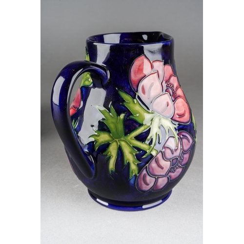 154 - A Moorcroft Anemone jug on cobalt blue ground, impressed mark, WM initials, 34/94, approx 14.5cm tal... 