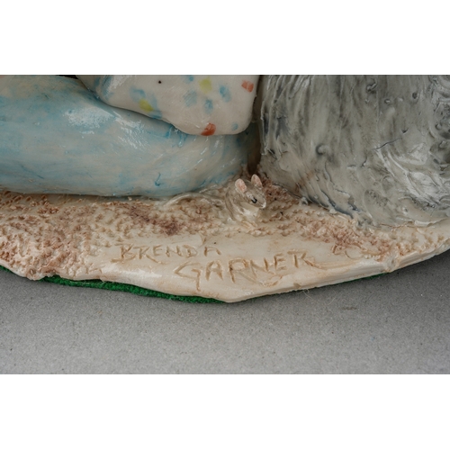 205 - A Modern glazed pottery model of a girl with her dog, signed Brenda Garner and a figure of a standin... 