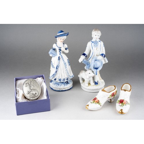 210 - A pair of continental 18th Century style blue and white figures, including boy and girl, the boy wit... 