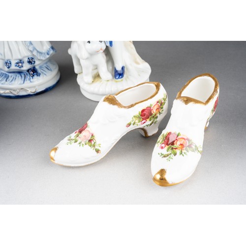 210 - A pair of continental 18th Century style blue and white figures, including boy and girl, the boy wit... 