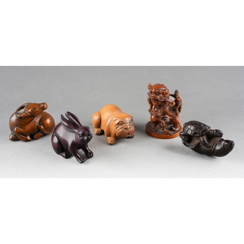 A collection of five Japanese Netsuke to include a rabbit, buffalo, dog ...