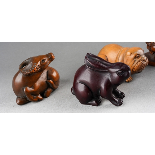 A collection of five Japanese Netsuke to include a rabbit, buffalo, dog ...