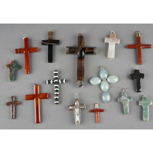 A collection of fifteen hardstone and other crosses, mostly with pendant mounts, the largest in banded agate with hallmarked silver mount for Birmingham 1900, height 92mm approx (1 bag)