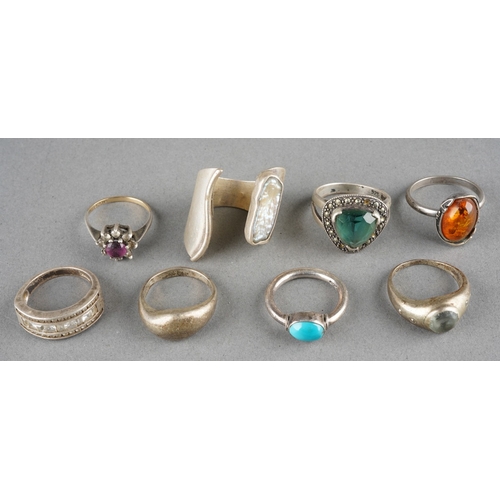 A collection of eight silver and white metal rings, majority stamped ...