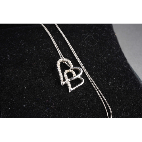 951 - Two 9ct gold and white metal diamond set pendants with chains. One pendant hallmarked 9ct gold, one ... 
