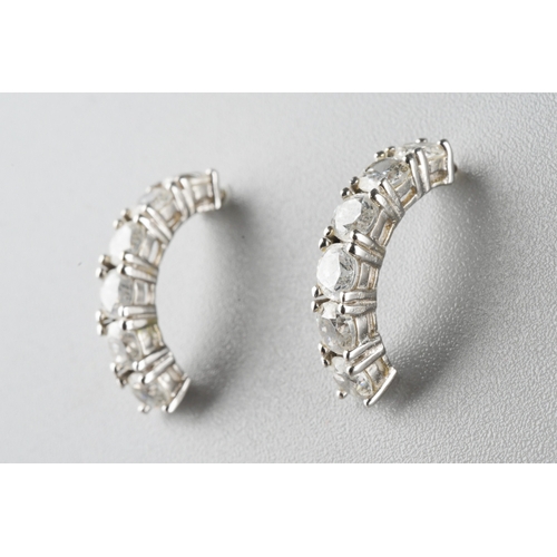 955 - A pair of white metal cubic zirconia earrings. Stamped 14k, approx gross weight 1.95grams.