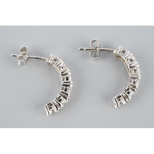 955 - A pair of white metal cubic zirconia earrings. Stamped 14k, approx gross weight 1.95grams.