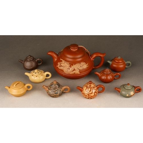 Eight Chinese Yixing style clay miniature teapots and a larger teapot ...