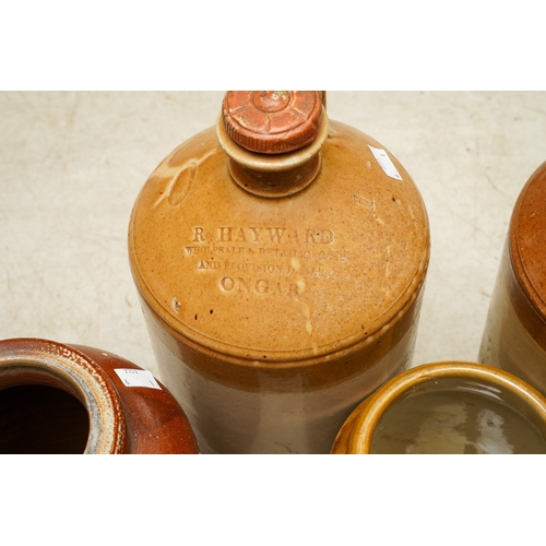 5 - Six Stoneware storage vessels / flagons, the jars unbranded, the three flagons with impressed brandi... 