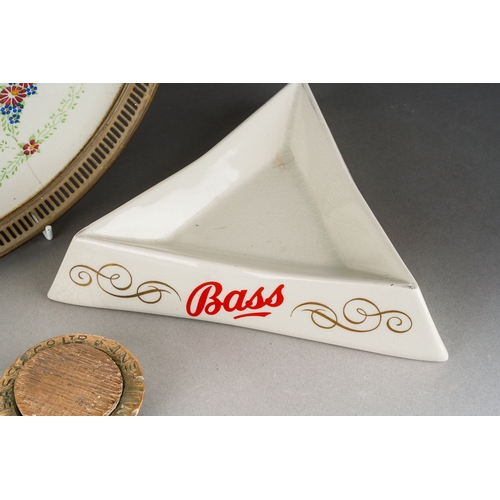 10 - Breweryana including Bass ashtrays, a Bass screw on casket top with wooden cork and a decorative cer... 