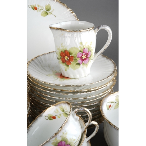 31 - A late 19th / early 20th century Continental porcelain tea set painted with pink and red flowers, co... 
