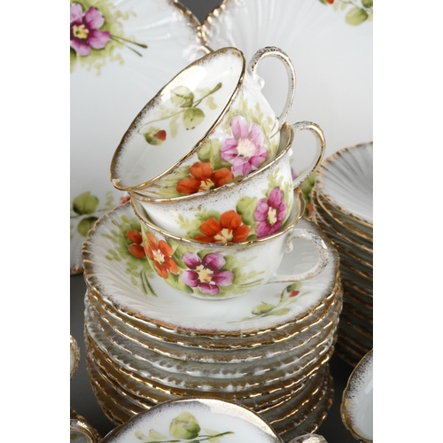31 - A late 19th / early 20th century Continental porcelain tea set painted with pink and red flowers, co... 