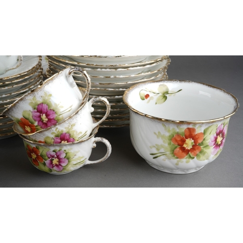 31 - A late 19th / early 20th century Continental porcelain tea set painted with pink and red flowers, co... 