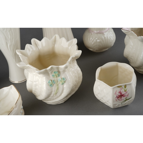 56 - A collection of late 20th Century Belleek comprising six vases and two jardinieres patterns include ... 