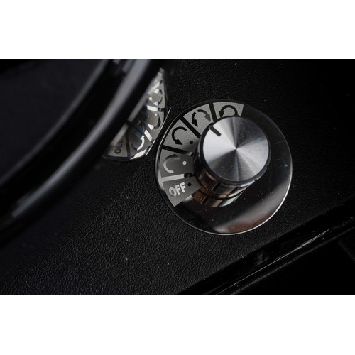 15 - A black finish automatic watch winding case for two watches, the glazed hinged sloped front enclosin... 