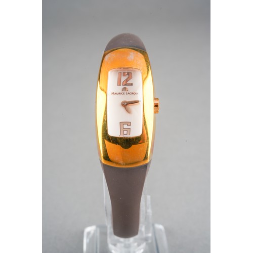 37 - A boxed Maurice Lacroix ladies gold plated and stainless steel wrist watch on a brown rubber bangle ... 