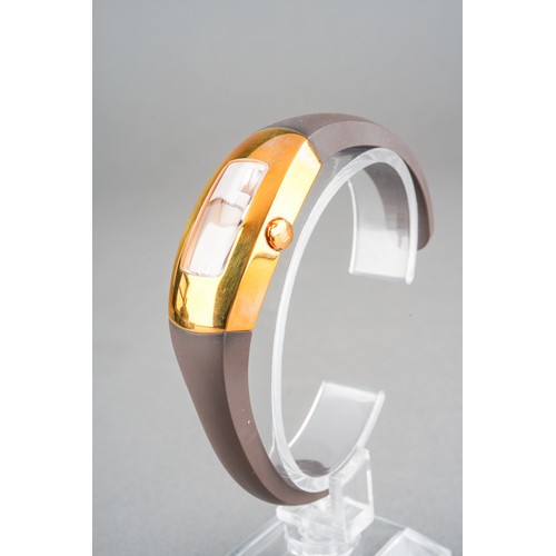 37 - A boxed Maurice Lacroix ladies gold plated and stainless steel wrist watch on a brown rubber bangle ... 
