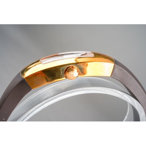 37 - A boxed Maurice Lacroix ladies gold plated and stainless steel wrist watch on a brown rubber bangle ... 