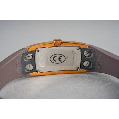 37 - A boxed Maurice Lacroix ladies gold plated and stainless steel wrist watch on a brown rubber bangle ... 