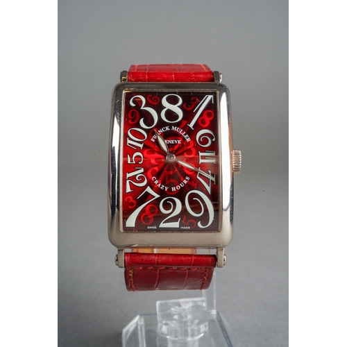 A Franck Muller 'Long Island Crazy Hours' 18ct white gold automatic wristwatch. The rectangular-shaped red guilloche enamel dial, with luminous Arabic numerals and luminous lozenge-shaped hands, the dial is signed 'Franck Muller Geneve Crazy Hours Swiss Made', case dimensions approx 32mm by 44mm, size of watch face approx 39mm h x 25mm w, including lugs approx 59mm h, the watch is on a red leather strap with diamond set tangle style bucke, case back signed 'Franck Muller Geneve Master of Complications No 513 1200 CH Long Island', together with swiss control marks for 18ct gold, watch with accompanying Franck Muller case and papers (dated 14.12.2010) and additional red leather strap with buckle and additional black leather strap (excluding buckle), we cannot guarantee the accuracy or working order of any watch sold, approx gross weight of watch 124.77grams.