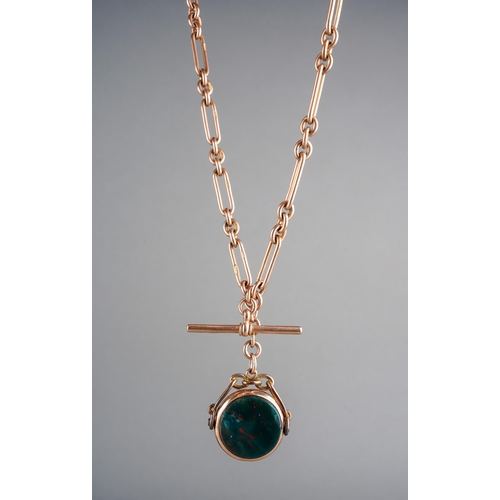 A 9ct rose gold T-bar necklace/chain with 9ct gold extender links and a 9ct gold mounted red and green swizzle fob, approximate length of the chain 41cm and approximate gross total weight including fob 52.4g