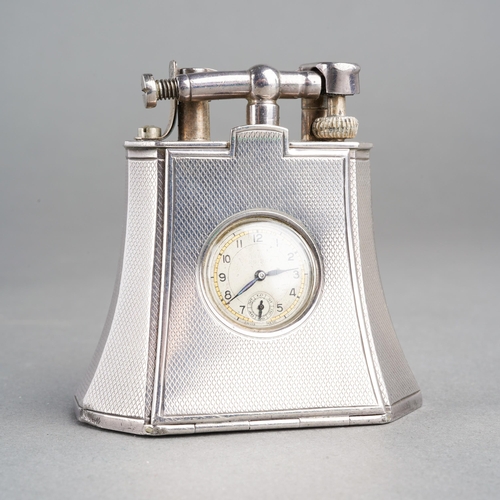 A RARE ART DECO SILVER DUNHILL COMBINATION LIGHTER TIMEPIECE. The case with engine turned detail, the hinged front panel comprising a circular-shape cream dial with black Arabic numerals, gilt chapter ring, dial signed 'Rotary Swiss Made', manual wind 15 jewels swiss movement (currently ticking), hallmarked 925 silver London 1927, signed Dunhill together with sponsors mark AD (Alfred Dunhill & Sons), PAT No 143752, approx height 60mm, we cannot guarantee the accuracy or working order of any time piece or lighter sold.
