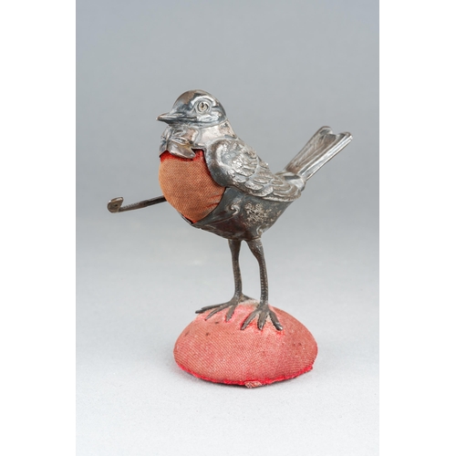 Edwardian silver pin cushion in the form of a robin, with a golf club under its wing.  Made in 1910 by Levi & Salaman, approx. 8cm tall