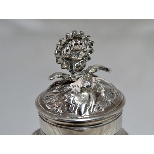 305 - A George II period silver tea caddy of baluster form raised on a circular foot, the sides chased wit... 