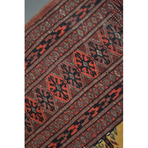 7 - A red and gold ground Bokhara style rug - Approx 5ft 10