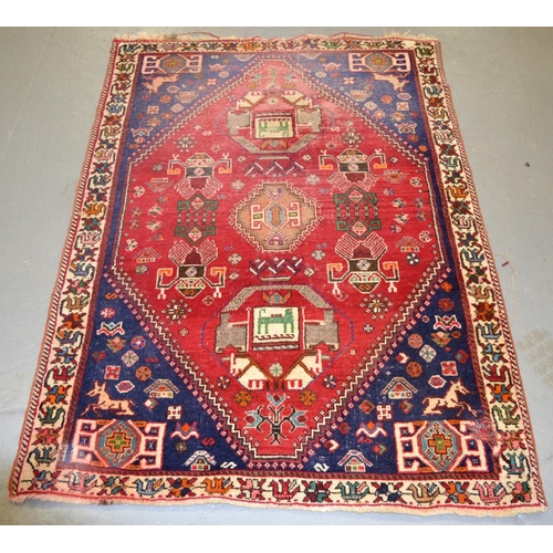 12 - An unusual red and blue ground rug - approx 4ft 5