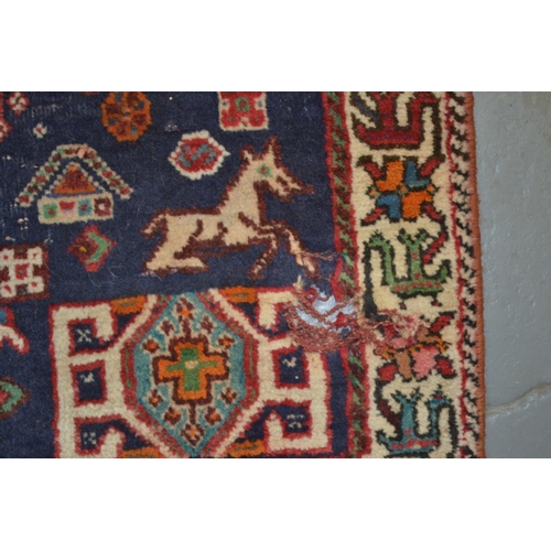 12 - An unusual red and blue ground rug - approx 4ft 5