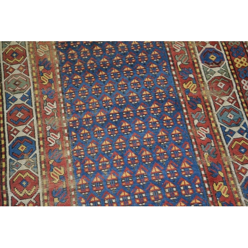 13 - A large colourful hand knotted rug runner - approximately 9ft 6