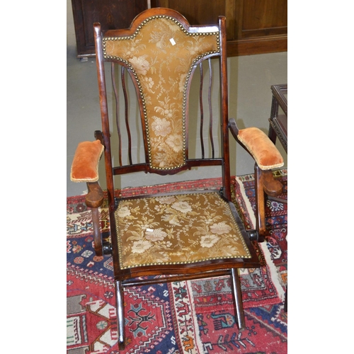 29 - A late 19th century/ early 20th century folding campaign chair with upholstery