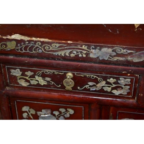 35 - An unusual red lacquer and mother of pearl inlaid cabinet. Believed to be Korean c.1920