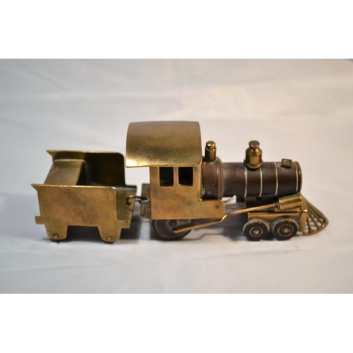 425 - A rare and unusual early 20th century brass and Bakelite model train with carriage. Probably WW2 per... 